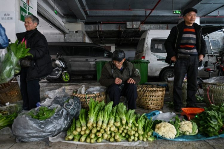 The image of farmers hauling their wares past Chongqing's skyscrapers is a reminder that making a living is still a struggle for many in China. ©AFP