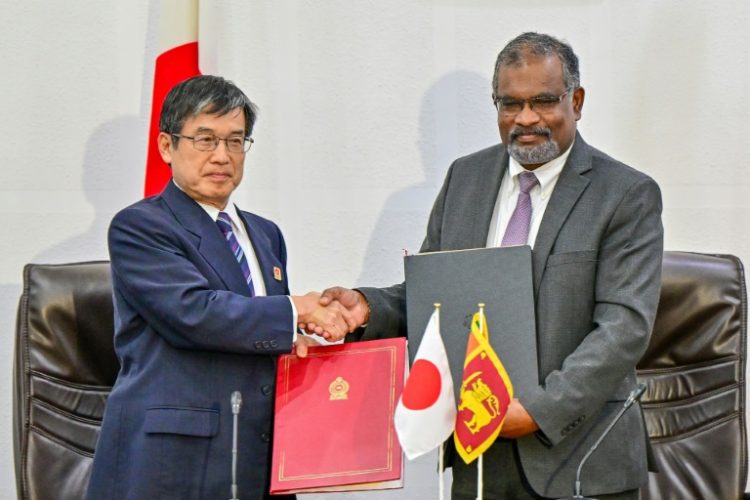 Japan's ambassador to Sri Lanka Akio Isomata (left) with Sri Lanka finance ministry secretary Mahinda Siriwardana after signing the debt restructuring agreement. ©AFP